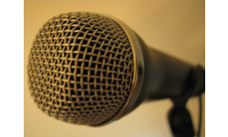  PIcture of a Microphone, signifying to click here to access the Oral and Video Histories.